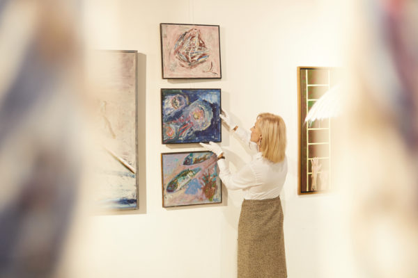 Art Gallery Manager Hanging Paintings