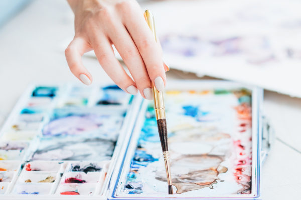 art school woman mixing paint colors brush palette
