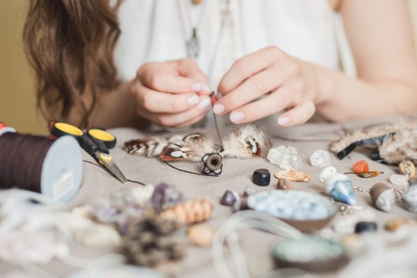 Woman hands making handmade gemstone jewelry